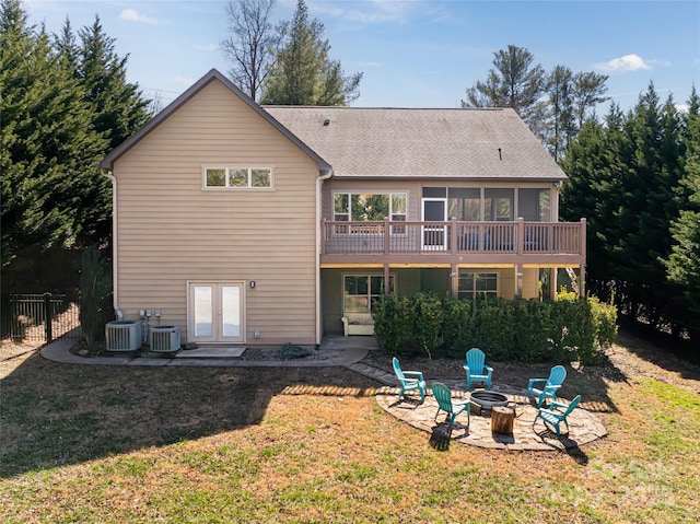 rear view of house featuring an outdoor fire pit, french doors, a patio, and a lawn