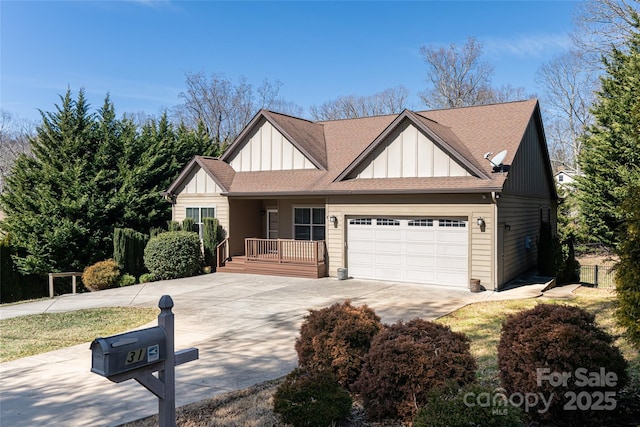 view of front of house featuring roof with shingles, a porch, concrete driveway, an attached garage, and board and batten siding