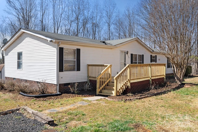 view of front of house featuring a front yard, crawl space, and a deck