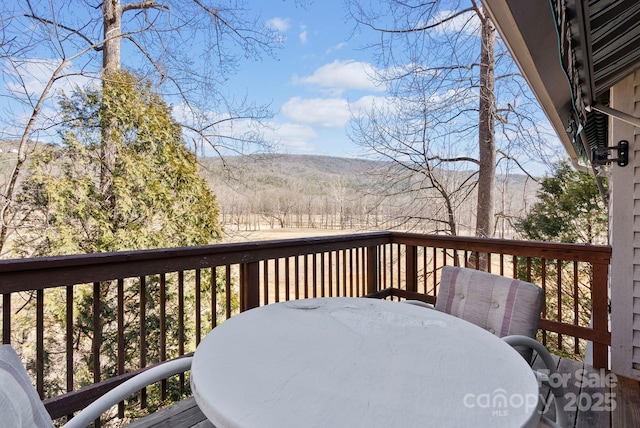 wooden terrace with outdoor dining area