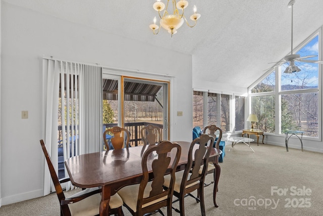 carpeted dining room featuring lofted ceiling, baseboards, a textured ceiling, and ceiling fan with notable chandelier