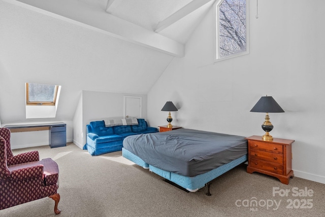 bedroom with lofted ceiling with skylight, carpet flooring, and baseboards