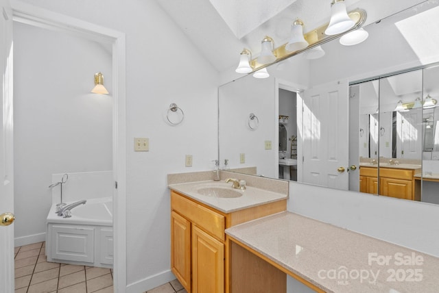 full bathroom with a skylight, vanity, a bath, and tile patterned floors