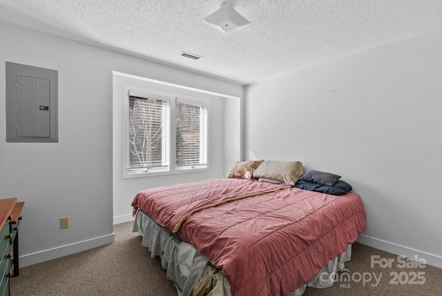 carpeted bedroom featuring baseboards, electric panel, visible vents, and a textured ceiling