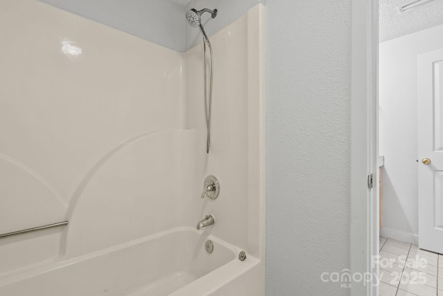 full bath with a textured ceiling, a textured wall, bathtub / shower combination, and tile patterned floors