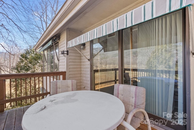 wooden terrace with outdoor dining area