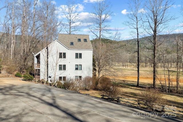 view of property exterior featuring roof with shingles