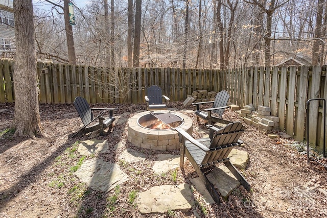 view of yard featuring an outdoor fire pit and a fenced backyard