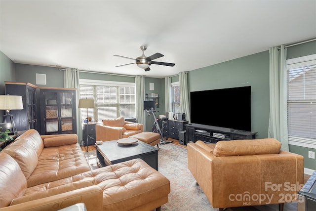 living area featuring ceiling fan and wood finished floors