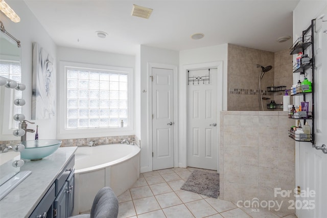 full bath featuring visible vents, tile patterned floors, a garden tub, walk in shower, and vanity