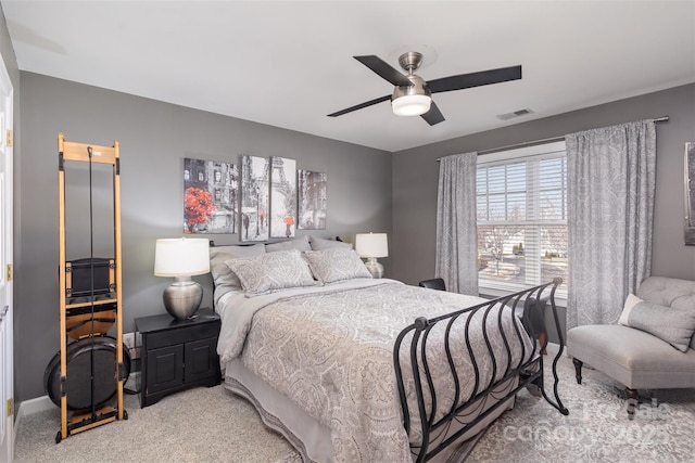 bedroom featuring a ceiling fan, light colored carpet, visible vents, and baseboards