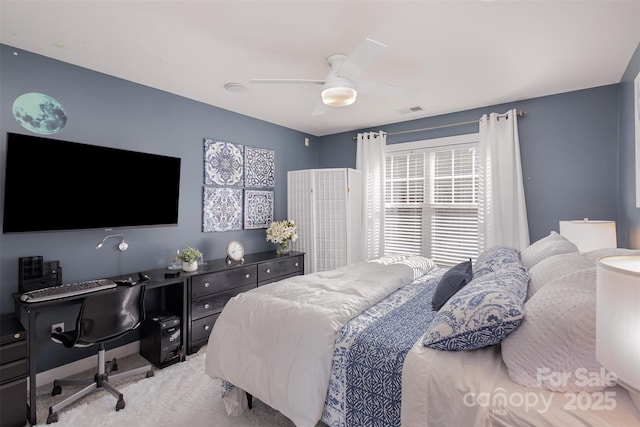 carpeted bedroom featuring ceiling fan and visible vents