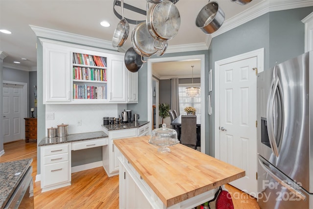 kitchen featuring butcher block countertops, light wood-style floors, white cabinets, stainless steel fridge with ice dispenser, and crown molding