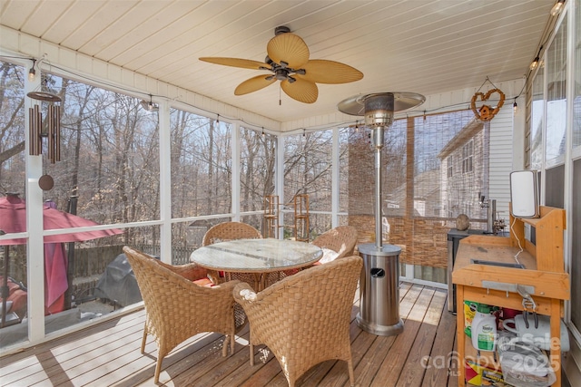 sunroom with wooden ceiling and a ceiling fan