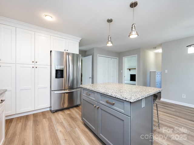 kitchen with white cabinetry, light wood-style floors, stainless steel refrigerator with ice dispenser, and gray cabinetry