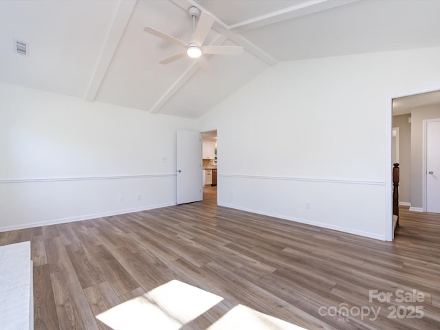 empty room featuring visible vents, lofted ceiling with beams, baseboards, and wood finished floors