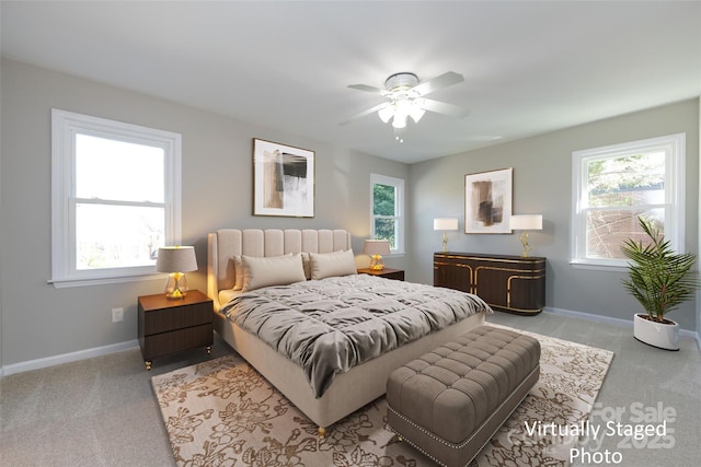 carpeted bedroom with a ceiling fan and baseboards