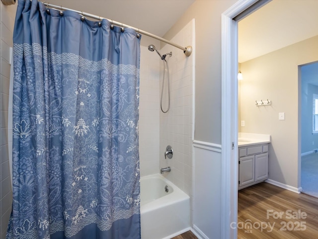 full bath with shower / bathtub combination with curtain, vanity, baseboards, and wood finished floors