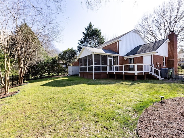 view of yard featuring fence, a deck, and a sunroom