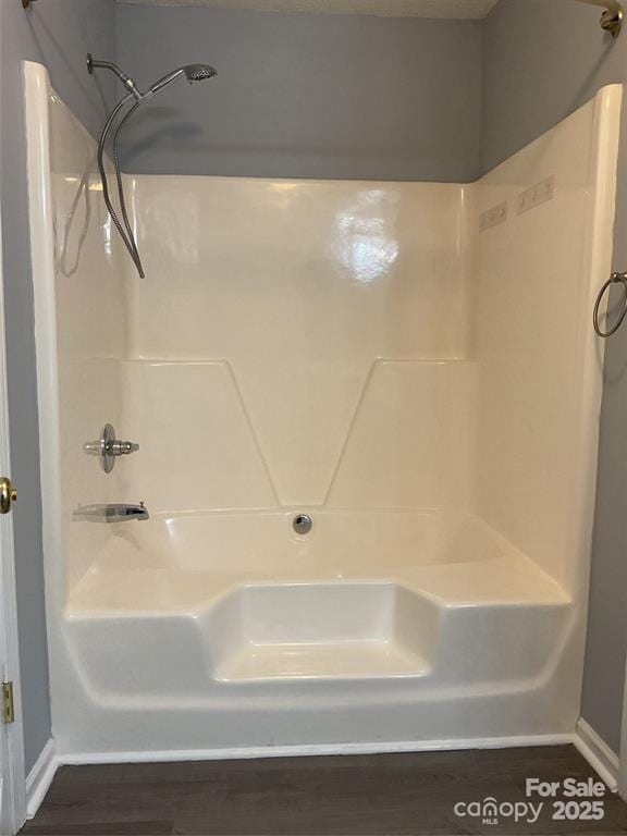 bathroom featuring a shower and wood finished floors