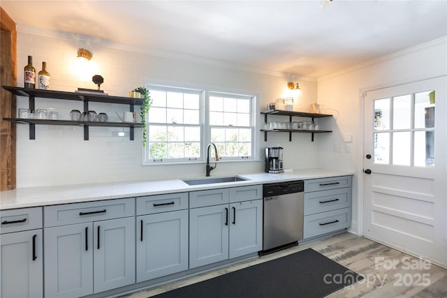 kitchen featuring open shelves, tasteful backsplash, stainless steel dishwasher, ornamental molding, and a sink