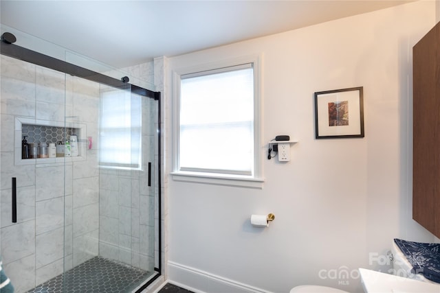 full bath with toilet, a shower stall, baseboards, and vanity