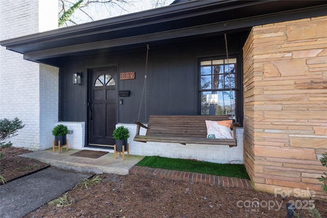 view of exterior entry with a porch