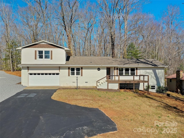 view of front of property featuring a garage, aphalt driveway, a front yard, and brick siding