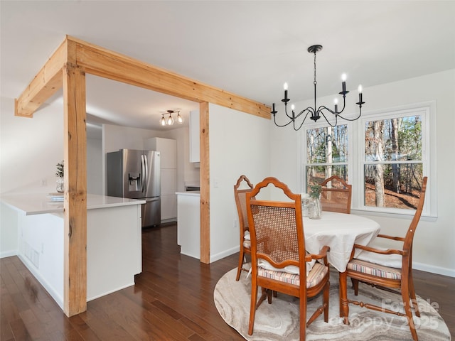 dining area featuring baseboards, a chandelier, dark wood-style flooring, and beamed ceiling