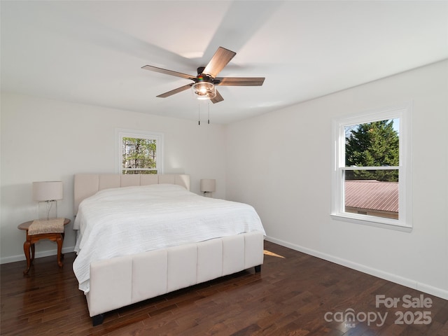 bedroom with ceiling fan, baseboards, and dark wood finished floors