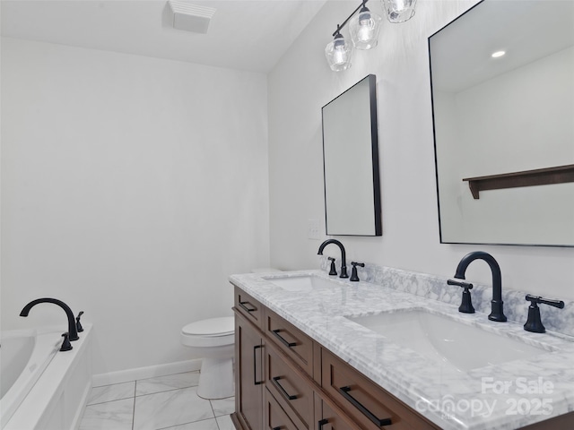 bathroom featuring marble finish floor, baseboards, a sink, and toilet