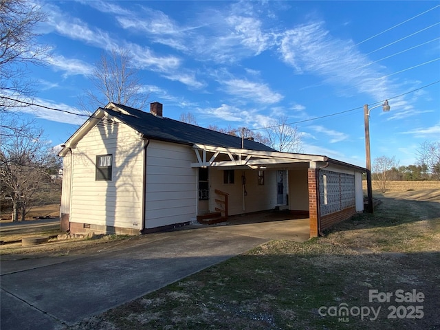 exterior space featuring a carport, crawl space, and a chimney