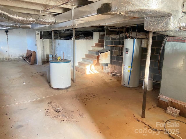 unfinished basement with water heater and stairway