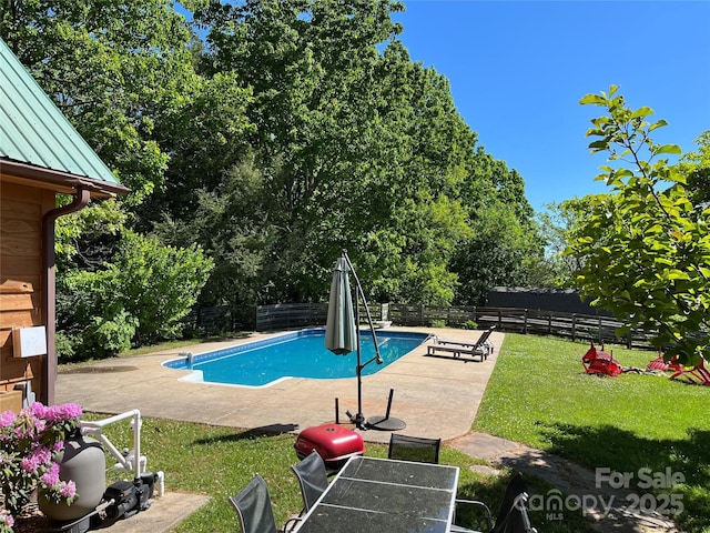 view of swimming pool with a fenced in pool, a lawn, a fenced backyard, and a patio area