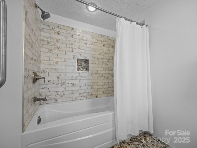 full bathroom featuring a textured ceiling and shower / tub combo with curtain