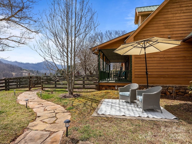 view of yard with a mountain view, a patio, and fence