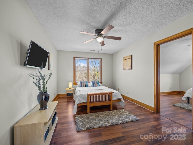 bedroom featuring wood finished floors, baseboards, and a textured ceiling