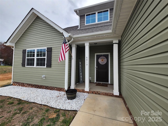 view of exterior entry with covered porch