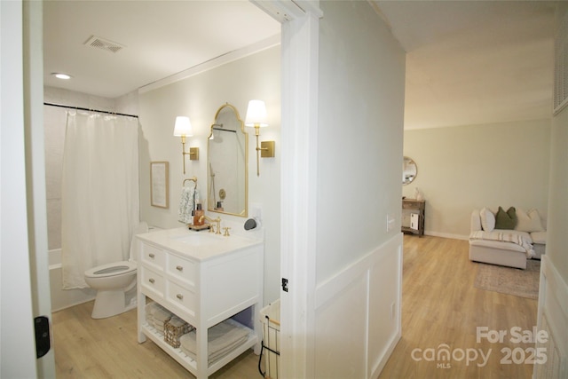 full bath with visible vents, vanity, wood finished floors, and toilet