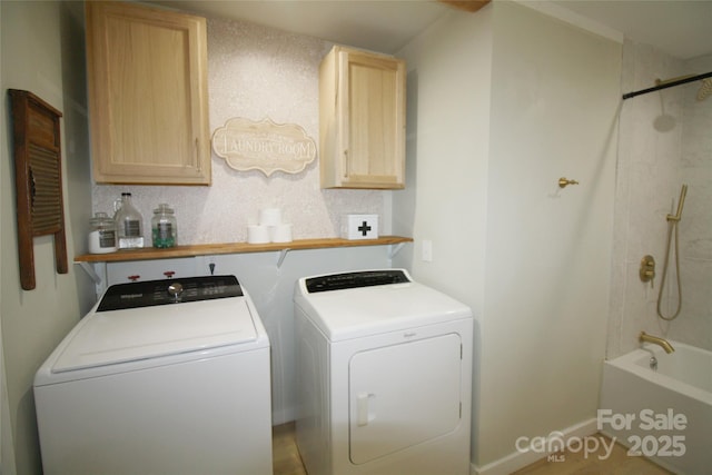 laundry room with washer and clothes dryer and cabinet space