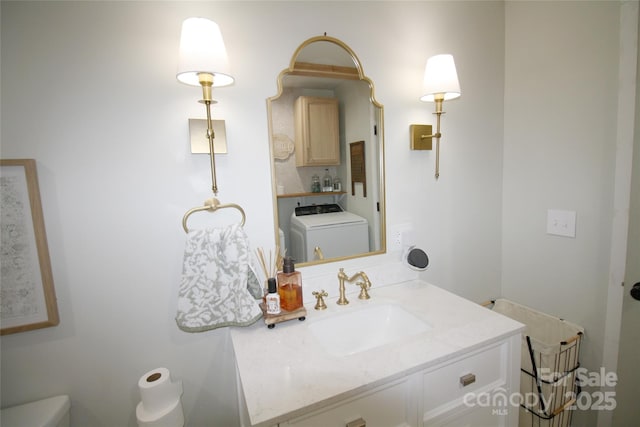 half bath featuring washer / clothes dryer, vanity, and toilet