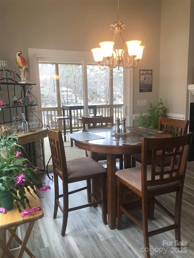 dining space with a chandelier and wood finished floors