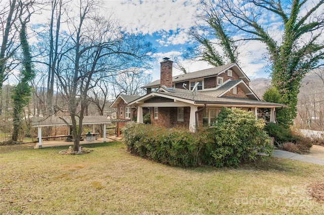 view of home's exterior featuring a chimney and a yard