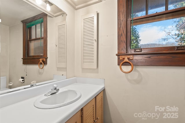 bathroom featuring vanity and toilet