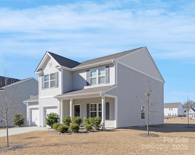 view of front facade featuring board and batten siding, concrete driveway, covered porch, and an attached garage