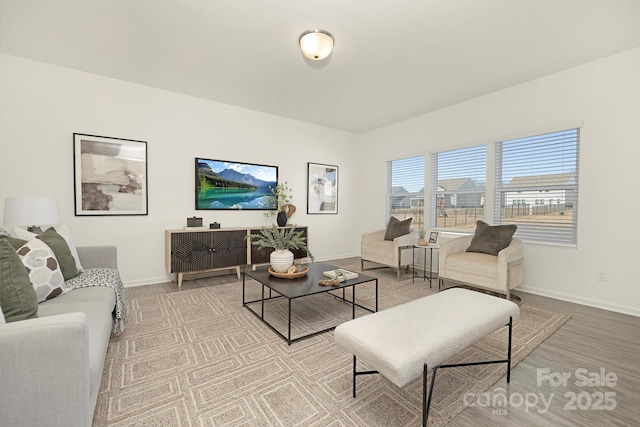 living room with light wood-type flooring and baseboards