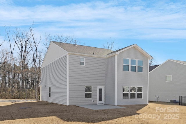 rear view of property with central air condition unit and a patio