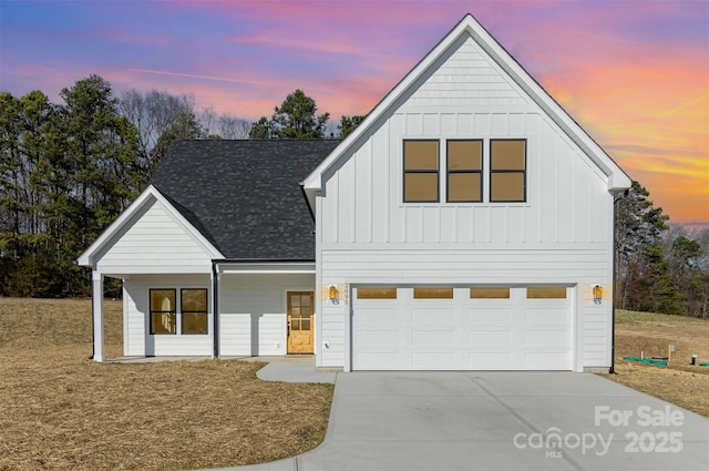 modern inspired farmhouse featuring a garage, concrete driveway, a shingled roof, and board and batten siding