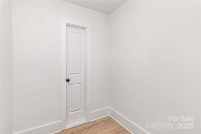 empty room with light wood-style floors and baseboards