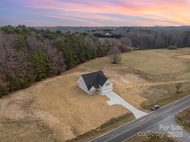 birds eye view of property with a rural view and a forest view